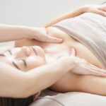 Dr. Ember Ewings demonstrating lymphatic drainage massage techniques for enhanced recovery after breast augmentation surgery.