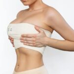 Dr. Ember Ewings advising on muscle tension relief after breast augmentation surgery for optimal healing.