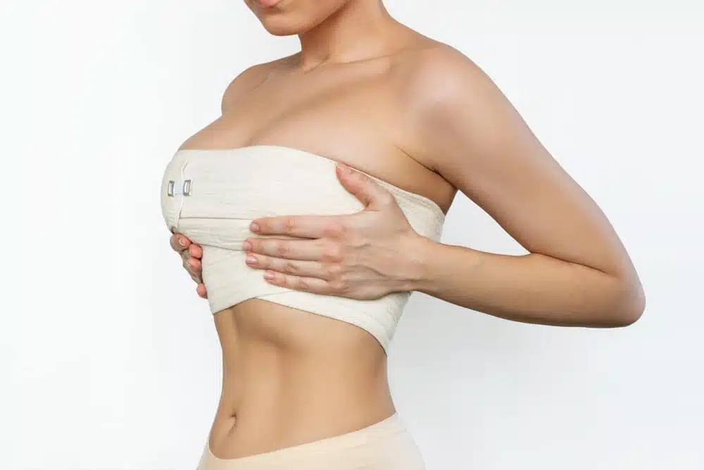 Dr. Ember Ewings advising on muscle tension relief after breast augmentation surgery for optimal healing.